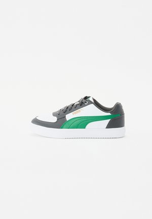 Sneakers featuring a gray leather upper with white and green accents, round toe, flat white outsole, and lace-up closure.