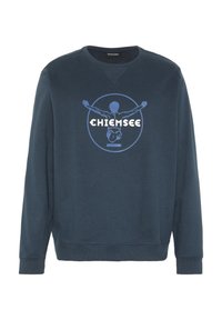 Navy blue sweatshirt with a round graphic featuring a figure and "CHIEMSEE" text in white and light blue. Ribbed neckline and cuffs.