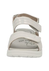 Light pink sandal with a smooth upper, three adjustable Velcro straps, and a white cushioned sole. Features a soft interior and logo on insole.