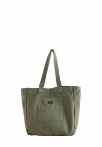 Olive green canvas tote bag with two long handles, a front pocket, and a logo patch, featuring a simple, structured design.