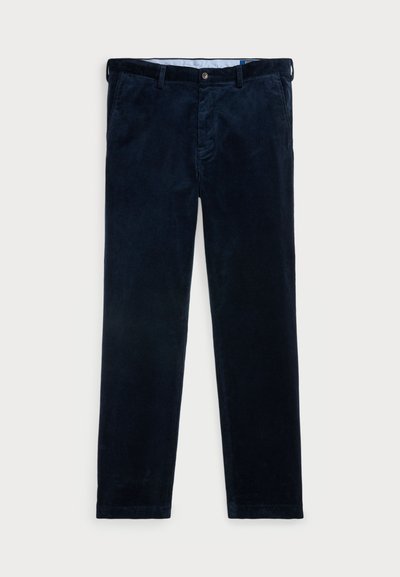 Tummansininen corduroy-housut suoranlahkeisella muotoilulla, jossa on nappikiinnitys, vyölenkit ja sivutaskut. Pehmeä, teksturoitu kangas.