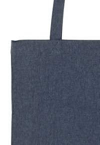 Borsa in tessuto blu navy con manici robusti, forma quadrata e texture liscia. Cuciture rinforzate nei punti di attacco dei manici per una maggiore durevolezza.