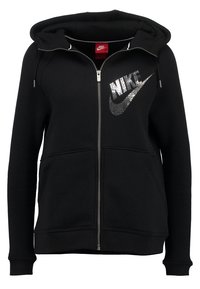 Svart zip-up hoodie i bomullsblandning, med en stor, glittrande Nike-logotyp på vänster bröst och två framfickor.