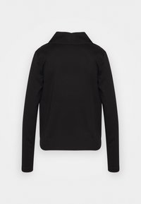 Maglietta nera a maniche lunghe con un colletto alto, realizzata in tessuto morbido. Design semplice senza fantasie o accessori. Vista posteriore mostrata.