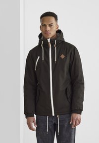 Black hooded jacket with white zippers, brown accents, and drawstrings. Features elastic cuffs and two front pockets.
