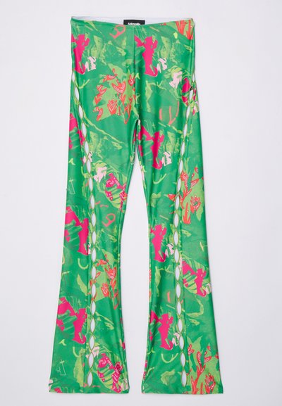 Green flared leggings with a floral and abstract pink pattern. Features cut-out details along the sides and a smooth, stretchy fabric texture.