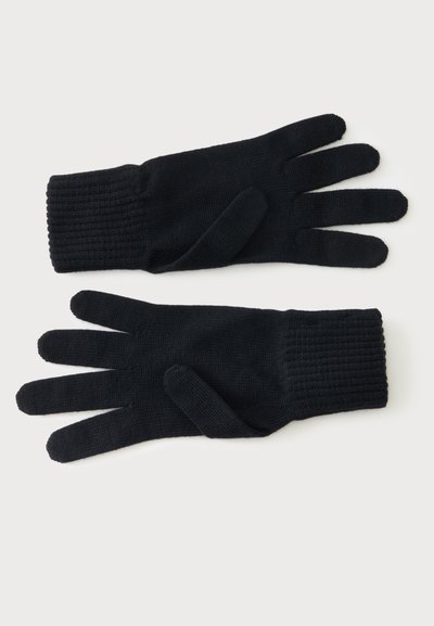 Paire de gants en maille noire avec poignets côtelés, présentés à plat avec les paumes vers le bas sur fond blanc.