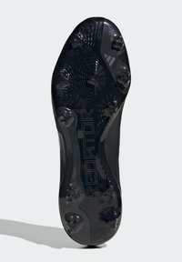 Soletta di scarpini da calcio nera con sei tacchetti testurizzati, un logo "PREDATOR" prominente e un design ergonomico curvato.