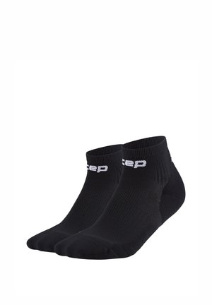 Pair of black ankle socks with white branded text on the cuff, made of ribbed knit fabric for athletic use.