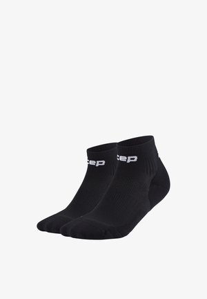 Paar schwarze Knöchelsocken mit weißem Markenschriftzug am Bündchen, hergestellt aus geripptem Strickstoff für sportlichen Gebrauch.