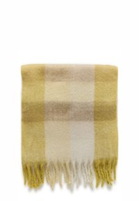 Gul og beige ternet tæppe med frynser på kanterne. Fremstillet af blødt stof, det har skiftevis firkanter i forskellige nuancer af gul og creme.