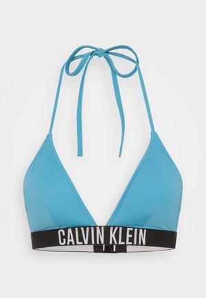 Soutien-gorge de bikini triangle bleu clair en tissu lisse. Présente une bande sous poitrine blanc et noir avec une fermeture à crochet. Se noue autour du cou.