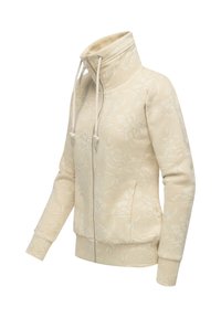 Giacca zip-up color crema con colletto alto e cordini, caratterizzata da un delicato motivo floreale e maniche lunghe.