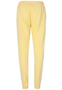 Gula joggarbyxor i mjukt tyg, med elastisk midja, smalnande ben och elastiska f�ållar vid anklarna.