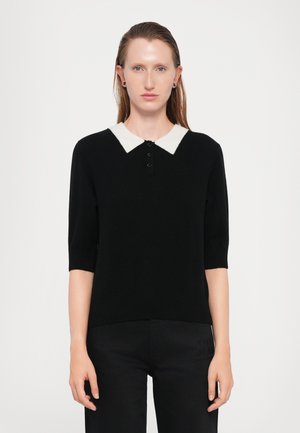 Black knitted polo sweater with short sleeves, featuring a contrasting white collar and four button placket, subtle ribbed texture.
