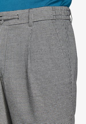 Pantalons à motif pied-de-poule en tissu noir et blanc, avec une coupe droite, des passants de ceinture et des poches latérales.