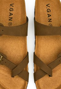 Brown vegan sandals with two adjustable straps and a cork insole. The interior features the brand name "V.GAN" and size 38.