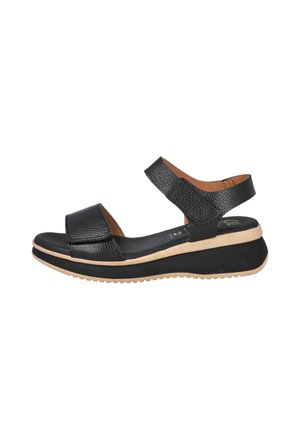 Sandalia negra de cuero con punta abierta, tiras ajustables, suela de plataforma acolchada en beige y negro, y acabado texturizado.