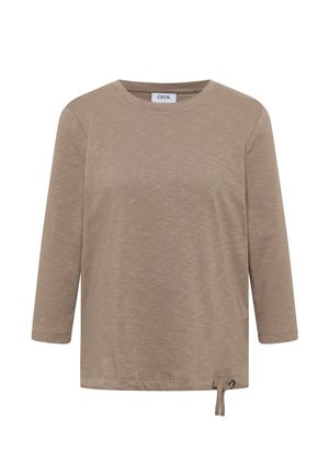 Beige long-sleeve top featuring a round neckline, textured fabric, and adjustable side tie detail for fit. Simple design with casual appeal.