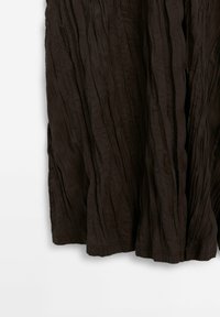 Dark brown crinkled fabric skirt with a flowing design. The texture displays prominent vertical creases and a hem that appears slightly uneven.