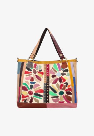 Large tote bag with double handles, decorated with colorful abstract petal shapes and vertical studded strips on cream background.