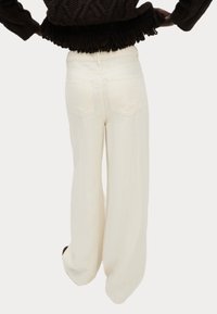 Pantaloni a gamba larga in tessuto crema, design a vita alta, con due tasche posteriori, texture liscia e vestibilità rilassata.