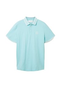 Polo en bleu clair, fabriqué en coton doux, avec une patte de boutonnage à deux boutons, des manches courtes avec bord blanc et un logo circulaire sur la poitrine.