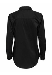 Chemise noire à manches longues boutonnée, vue de dos avec un col et des poignets boutonnés.