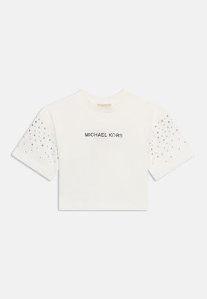 White cropped T-shirt with "MICHAEL KORS" text on front and small silver studs decorating the upper sleeves.