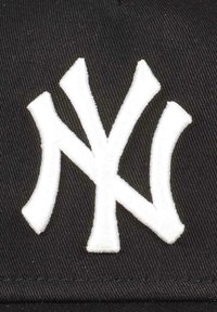 Black cap featuring a prominent white embroidered "NY" logo, with a textured fabric and structured shape.