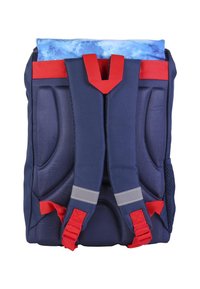 Navy blue backpack with red accents and straps. Features padded shoulder straps, gray reflective strip, and a blue patterned top flap.
