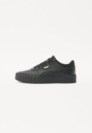 Black sneaker with a textured leather upper, flat laces, a thick platform sole, and gold PUMA logo on the side.