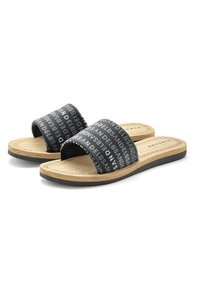 Black slide sandals with wide fabric straps featuring white text. Natural wood-like footbed and black rubber outsole, flat design.