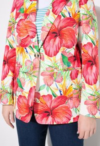 Blumen-Blazer mit großen roten Hibiskusblüten und tropischen Mustern. Aus leichtem Stoff gefertigt, mit einem silbernen Ein-Knopfbund und zwei Fronttaschen.