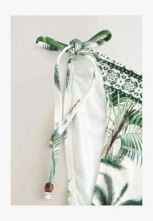 Zielony i biały biustonosz bikini z nadrukiem liści palmowych, z zapięciem nawiązującym do krawata i ozdobnymi koralikami. Miękka tkanina o gładkiej fakturze i elastycznym kroju.