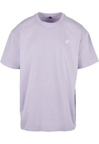 Light lavender cotton t-shirt with short sleeves, round neckline, and a small flower embroidery on the chest. Simple, relaxed fit.
