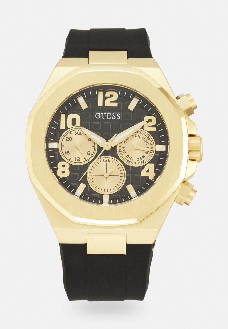 Reloj octogonal en tono dorado con correa de goma negra, cuenta con un dial negro texturizado, grandes números dorados y tres subdiales de cronógrafo.