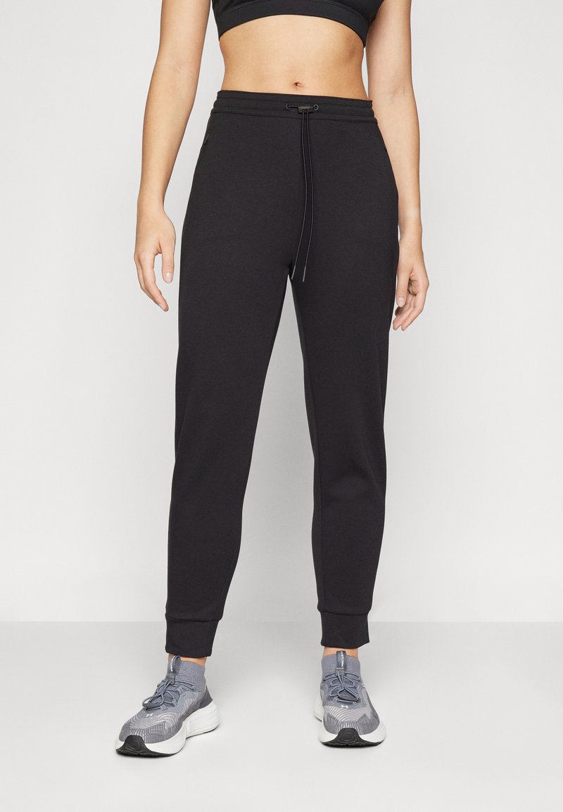Black sweatpants made of soft fabric, featuring a tapered design, elastic waistband with drawstring, and ribbed cuffs.