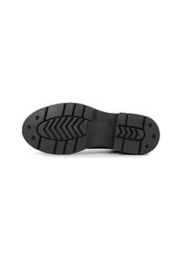 Black rubber shoe sole with a serrated tread pattern, featuring two large ridges and circular holes for added grip and durability.