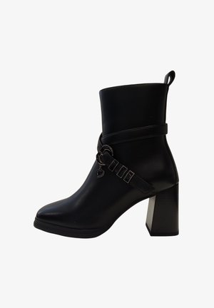 Stivale alla caviglia nero con tacco quadrato chunky, realizzato in pelle liscia, punta affusolata e una fibbia decorativa con un particolare a forma di cuore.