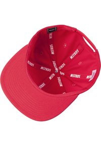 Red baseball cap with a curved brim, made from fabric. Interior features repeated "MSTRDS" branding and five ventilation holes.