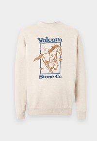Μπεζ φούτερ με μπλε κείμενο "Volcom Stone Co.", με ένα καφέ άλογο που τρέχει περιτριγυρισμένο από τρία αστέρια μέσα σε ορθογώνιο πλαίσιο.