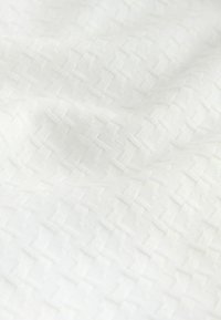 White fabric with a textured basketweave pattern, featuring raised squares and a smooth, soft finish. Suitable for various textile applications.