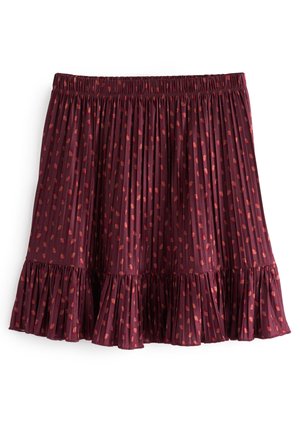 Jupe plissée bordeaux à pois rouges, taille élastique et ourlet volanté, présentée sur fond blanc.