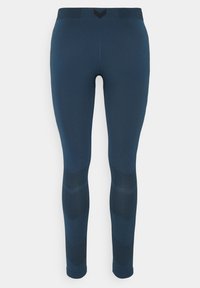 Granatowe legginsy wykonane z elastycznego materiału, z wysokim stanem, teksturowanym wzorem dzianiny na dolnych nogawkach oraz dopasowanym krojem.