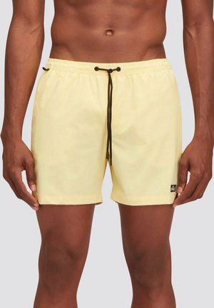 Pantaloni da bagno gialli realizzati in tessuto leggero, con vita elastica e cordino nero, di colore uniforme e un piccolo logo.
