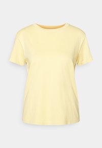 Short-sleeve, crew-neck t-shirt in soft yellow cotton. Smooth texture, a relaxed fit, and even stitching along the hems and neckline.