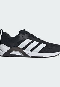 Black athletic shoe with a textured knit upper, white three stripes, and a black rubber heel support. Features a white sole with traction.