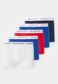 Five men's boxer briefs in white, blue, red, blue, and navy, each with a white waistband branded "GANT" in navy letters.