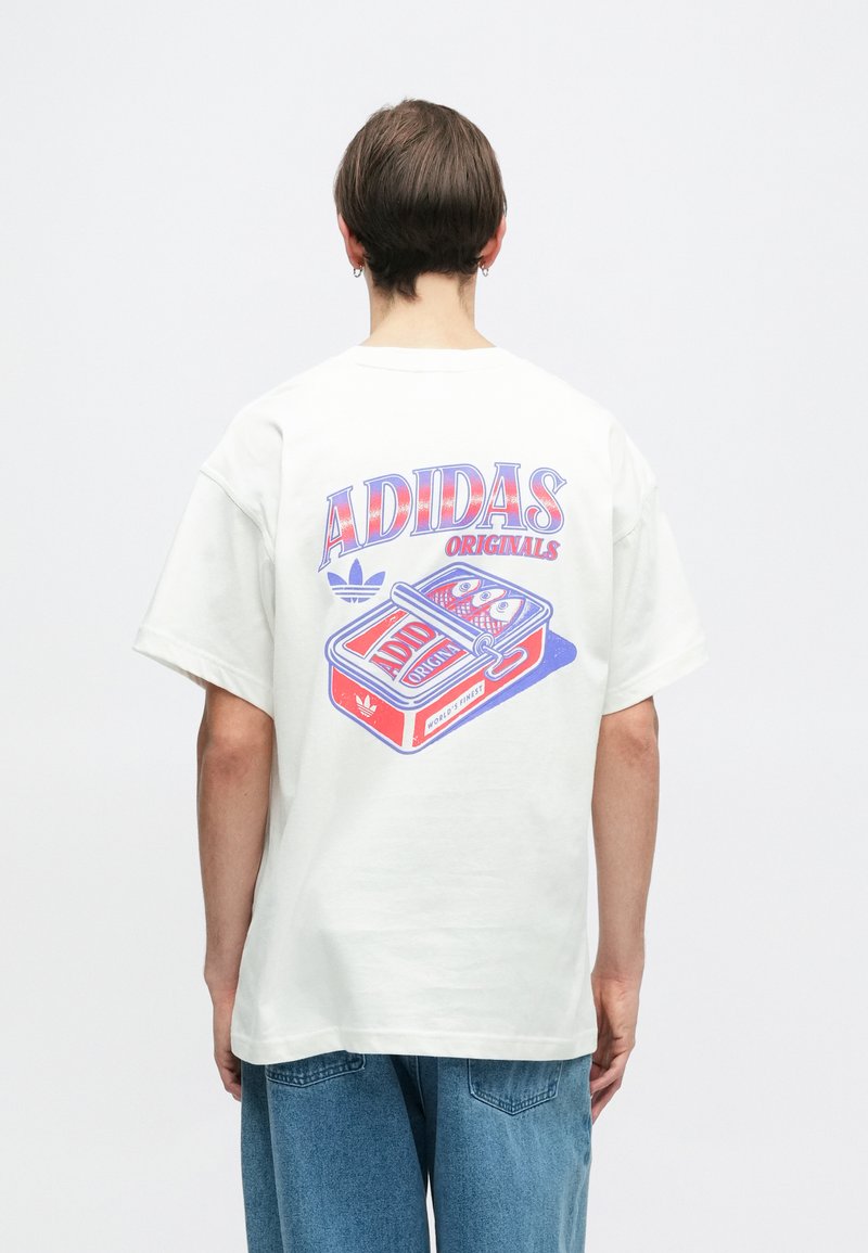 White cotton t-shirt featuring a colorful retro graphic on the back with "ADIDAS ORIGINALS" text, short sleeves, and a relaxed fit.